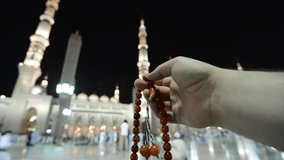 Muslim man praying in front of Medina holy mosque