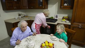 Cute children having a tea with their grandparents