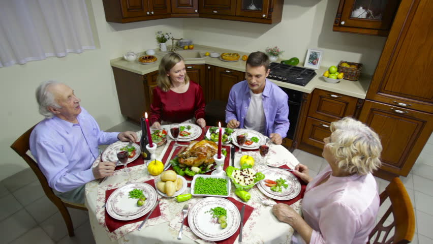 Two generations of a family having a dinner on a Thanksgiving day