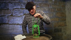Elderly man cleaning an old petroleum lamp in a dark cellar. High definition video. - Powered by Shutterstock - Get 15% off with code: PIKWIZARD15