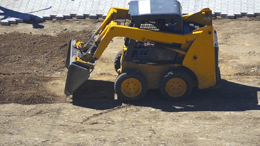Dozier Tracks - Stock Video. Bulldozer pushing dirt and preparing terrain for