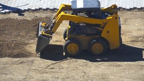 Dozier Tracks - Stock Video. Bulldozer pushing dirt and preparing terrain for pavement. Top view.