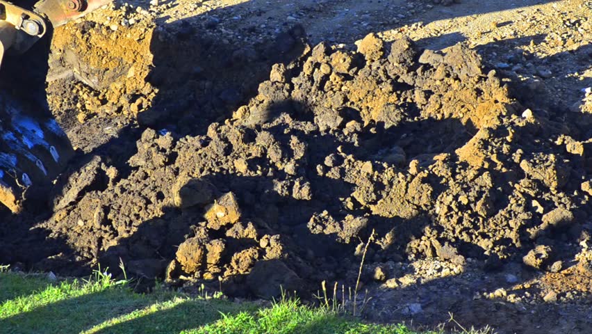Excavator Dumps Gravel - Stock Video. An excavator dumps its load of fill gravel