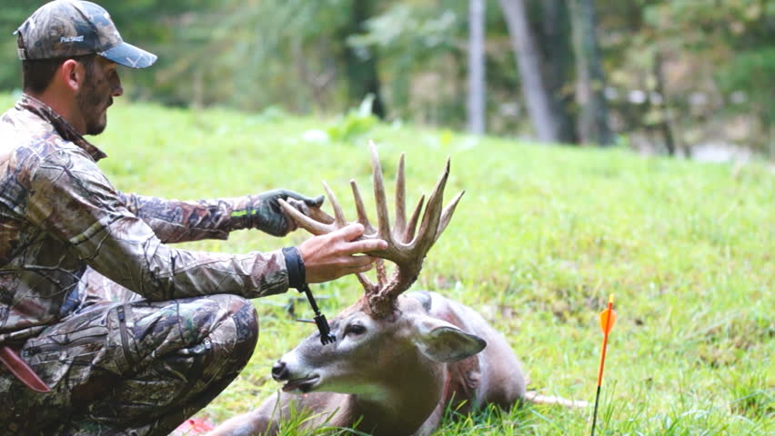 Successful archery hunter with his Whitetail Deer trophy buck.