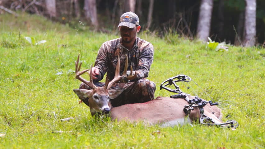 Successful archery hunter with his Whitetail Deer trophy buck.