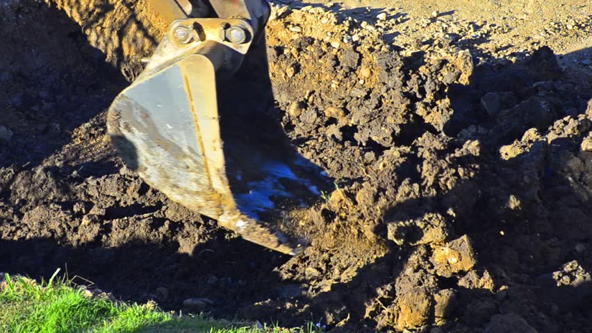 Construction Site - Stock Video. Front end loader digging up old concrete and