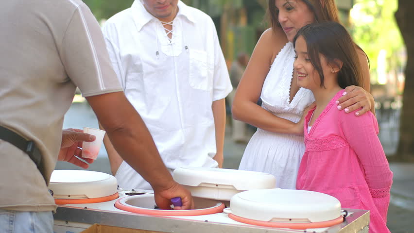A family waits for their ice cream from a street vendor