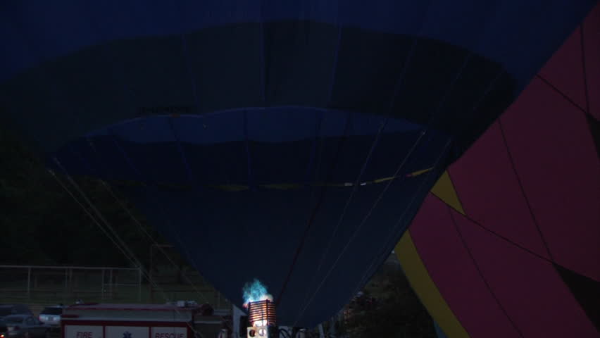 A hot air balloon gets inflated by propane gas.