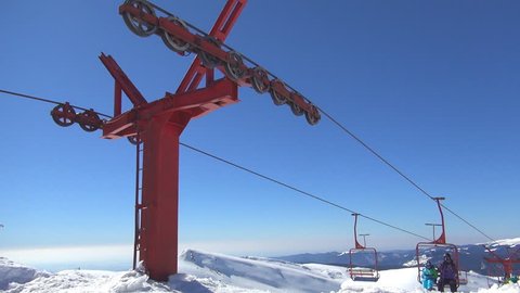 ROMANIA, BUCEGI, FEBRUARY 2,  2013, People Riding with Chairlift in Alps, Alpine View, Winter Sports, Skiing Slope