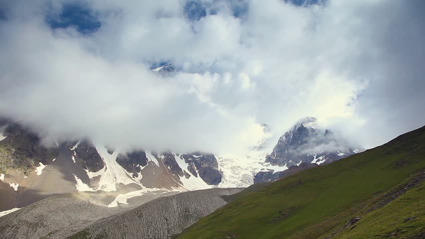 Alpine meadows with dramatic sky at the foot of  Mt. Ushba. Upper Svaneti,