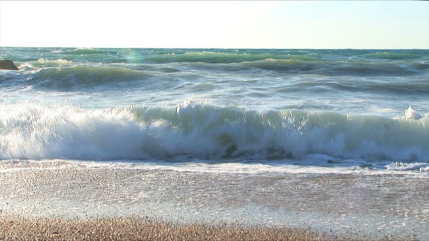 Beautiful waves fight about coast. Windy