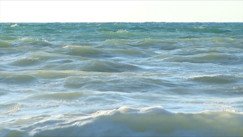 Beautiful waves fight about coast. Windy