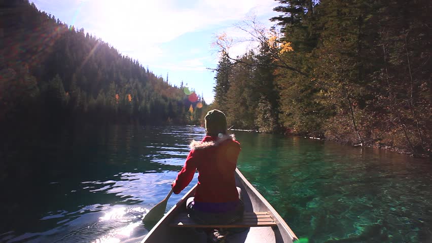EPIC CANOE RIDE WITH GIRL IN VIBRANT LAKE

A peaceful canoe floats atop a crystal clear glacial lake, as a girl navigates through a forested valley. Rich outdoor colors and sunny skies.