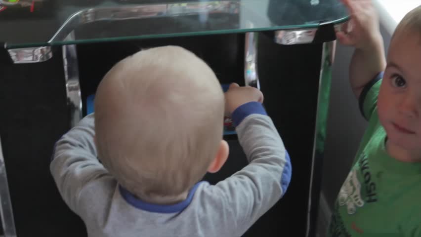 Toddlers playing with an old arcade