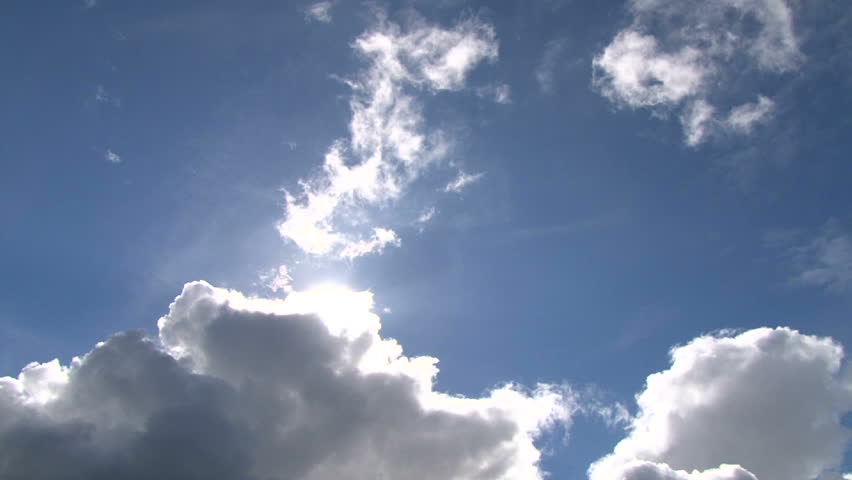 Time lapse of cloudscape with bright sun shining and revealing itself behind