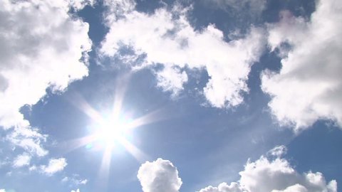 Time lapse of cloudscape with bright sun shining with clouds passing.