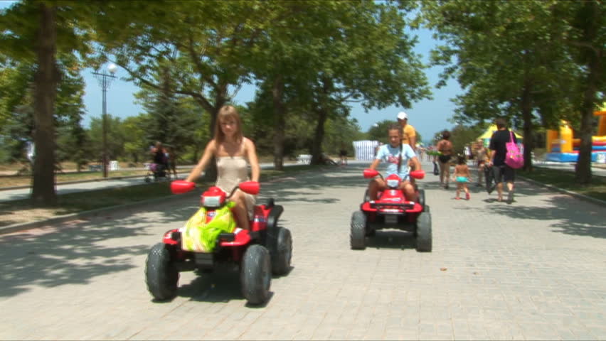 Two young girls go for a drive on atv