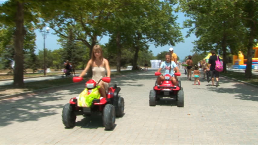 Two young girls go for a drive on atv's