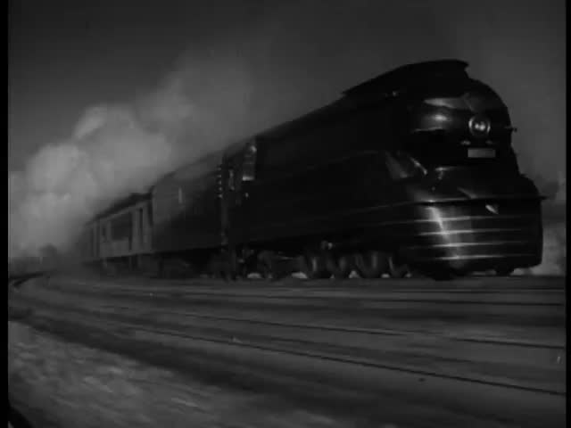 Steam locomotive in motion on tracks, 1940s