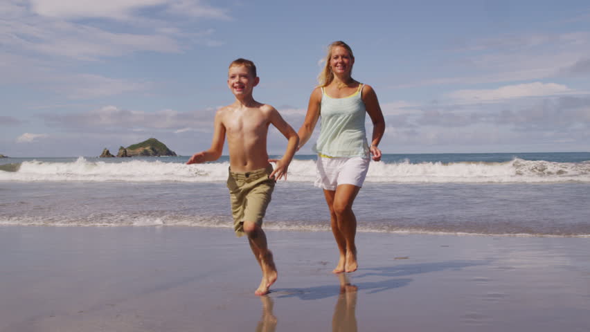 Mother and son running on beach, slow motion Shutterstock HD Video #4752977...