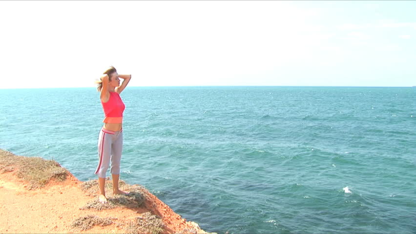 Beautiful girl admires the sea. Zoom in.