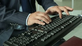 Close-up of a business worker inputting information via keyboard
