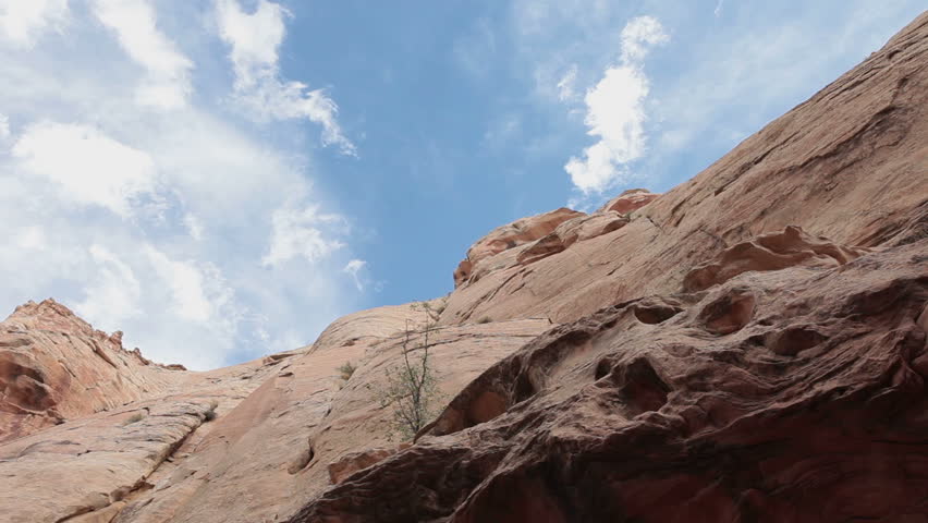 Slot canyon clouds passing fast motion timelapse. The San Rafael Swell desert geologic feature south Utah. Powerful flash floods have eroded the sedimentary rocks into valleys, canyons, gorges, mesa.