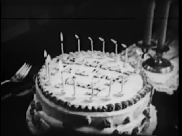 Close-up of lighted candles on birthday cake