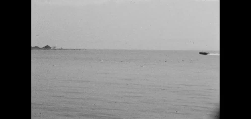 Wide shot of three people riding in speedboat