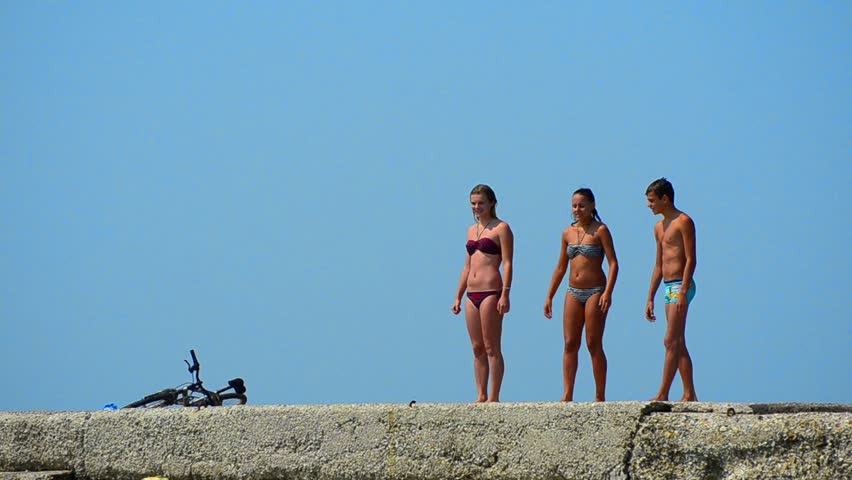 Summer Sea, Ocean, Pool Fun - Stock Video. Three teens jumping from concrete