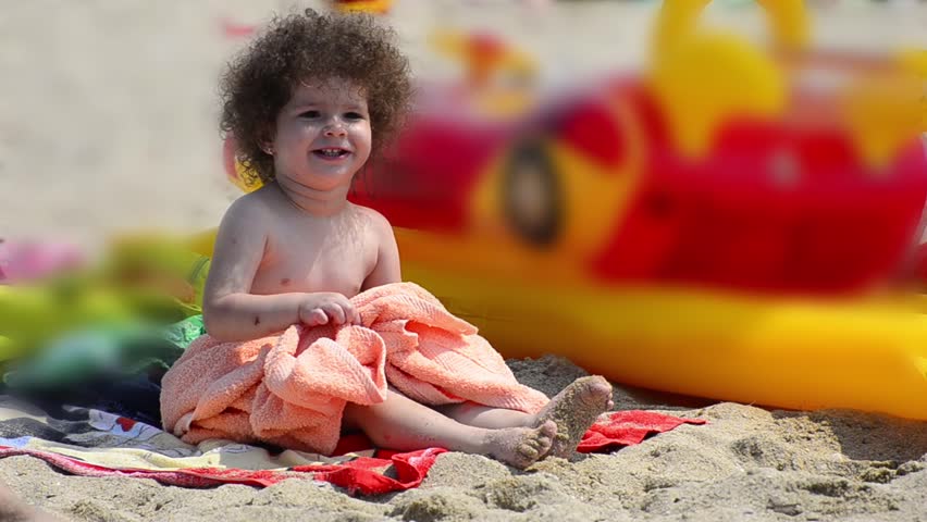 Summer time to get dry - Stock Video. An adorable little child gets relaxed and