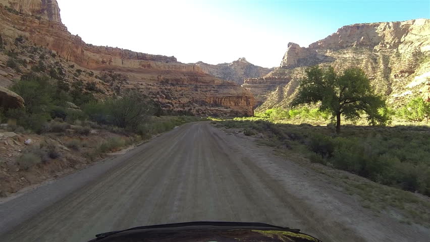 Buckhorn Wash San Rafael Utah drive POV point of view. Wheel of car hood desert dirt road POV point of view. Camera mounted outside of car. Vacation travel in southwestern Utah desert.