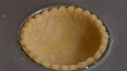 Child baking - putting pastry lids on fruit pies Stock Video