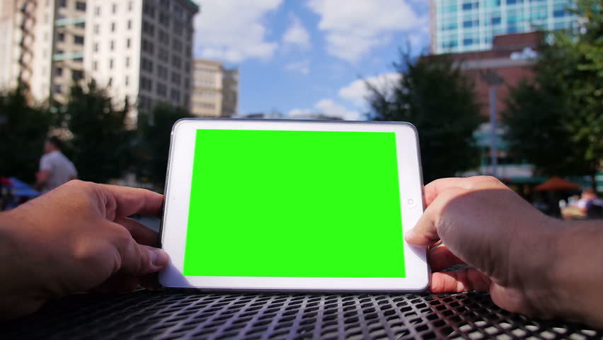 A man uses a tablet computer outside at Market Square in downtown Pittsburgh