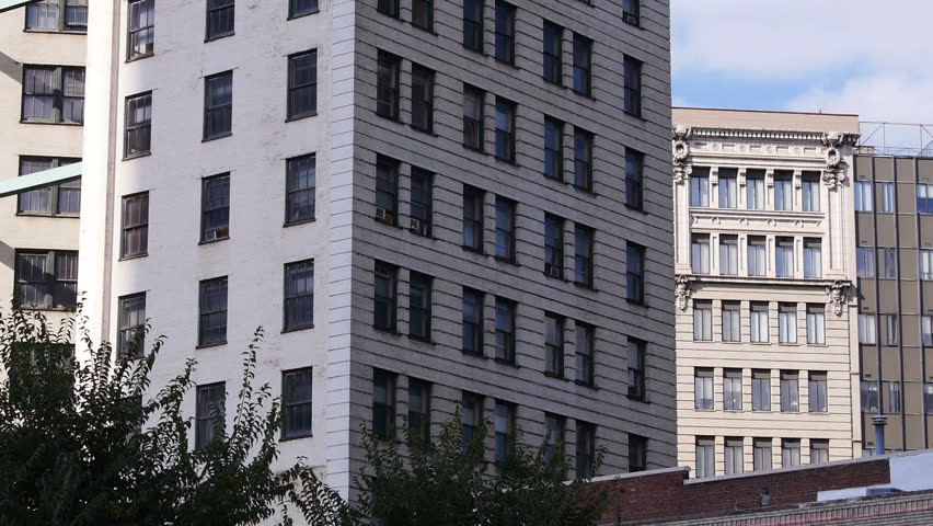 An establishing shot of a typical apartment building in a large city.