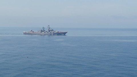 modern missile warship with a helicopter on board on the high seas