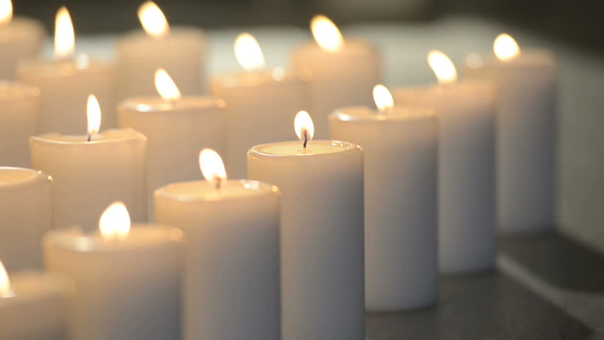 Edited Dolly Shot Of Multiple White Candles Burning Peacefully With Soft Candle