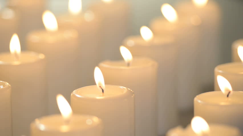Edited Dolly Shot Of Multiple White Candles Burning With Soft Candle Lights.