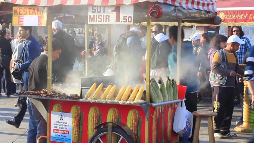 ISTANBUL - APRIL 12: An unidentified street vendor sells boiled corn and grilled