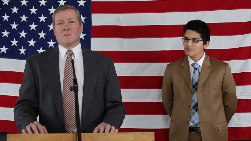 Men talking on podium