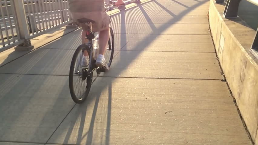 An extreme slow motion 120fps shot of a man riding his bicycle on a Pittsburgh