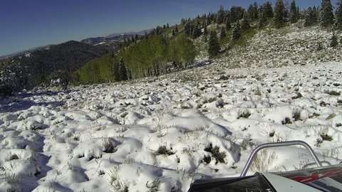 Deer hunter man hiking up snowy mountain fast timelapse. Snow blanket high mountain forest. Annual fall deer hunt activity and recreation. POV point of view.  Harvesting fresh meat for the winter.