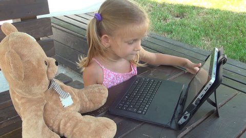 Child, Little Girl with Bear Toy Playing, Using Tablet Laptop, Computer, PC in Park, Children
