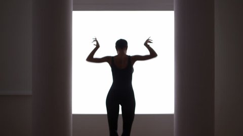 woman dancing in front of window Arkivvideo
