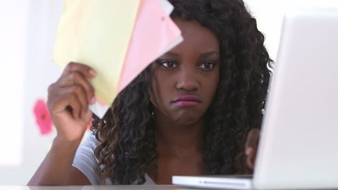 Unhappy black woman paying bills