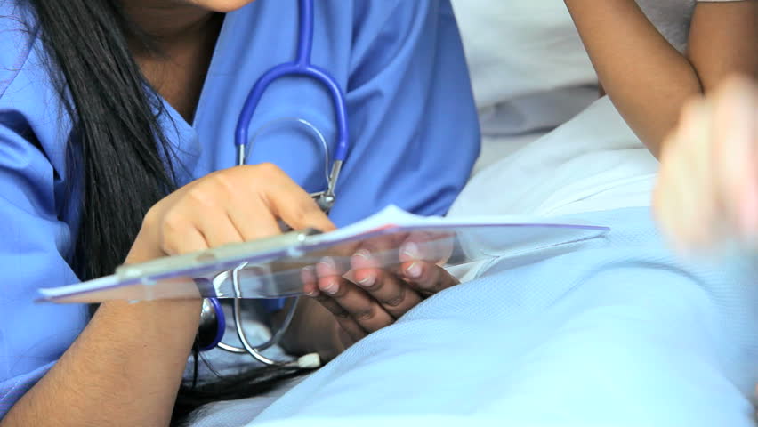 Female nurse explains treatment plan to a cute young patient in a children