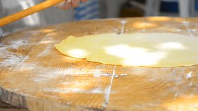 HD: Traditional Italian Food, Rolling The Dough - Stock Video. HD1080 Grandmother rolling dough for pizza pasta burek cakes cookes baklava/ Old traditional way on wooden table sitting on the floor.