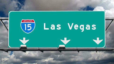 Las Vegas Interstate 15 fwy sign with time lapse clouds.