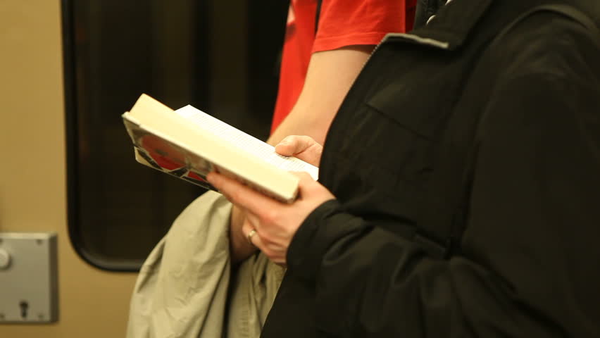 Reading book on subway