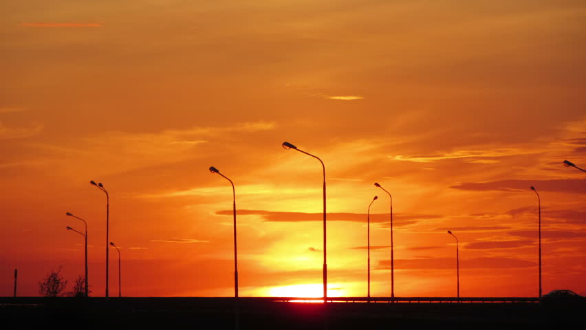 Cars silhouettes on road against sunset - timelapse